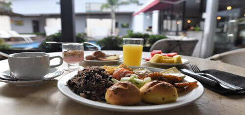 Picture of a wonderful meal served poolside by the Costa Rica Medical Center Inn while having dental work at Premier Holistic Dental in beautiful Costa Rica.  The picture shows a full course meal served with coffee and juice.