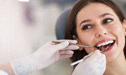Picture of a smiling woman with perfect white teeth having an Oral Surgery dental treatment at Premier Holistic Dental in beautiful Costa Rica.